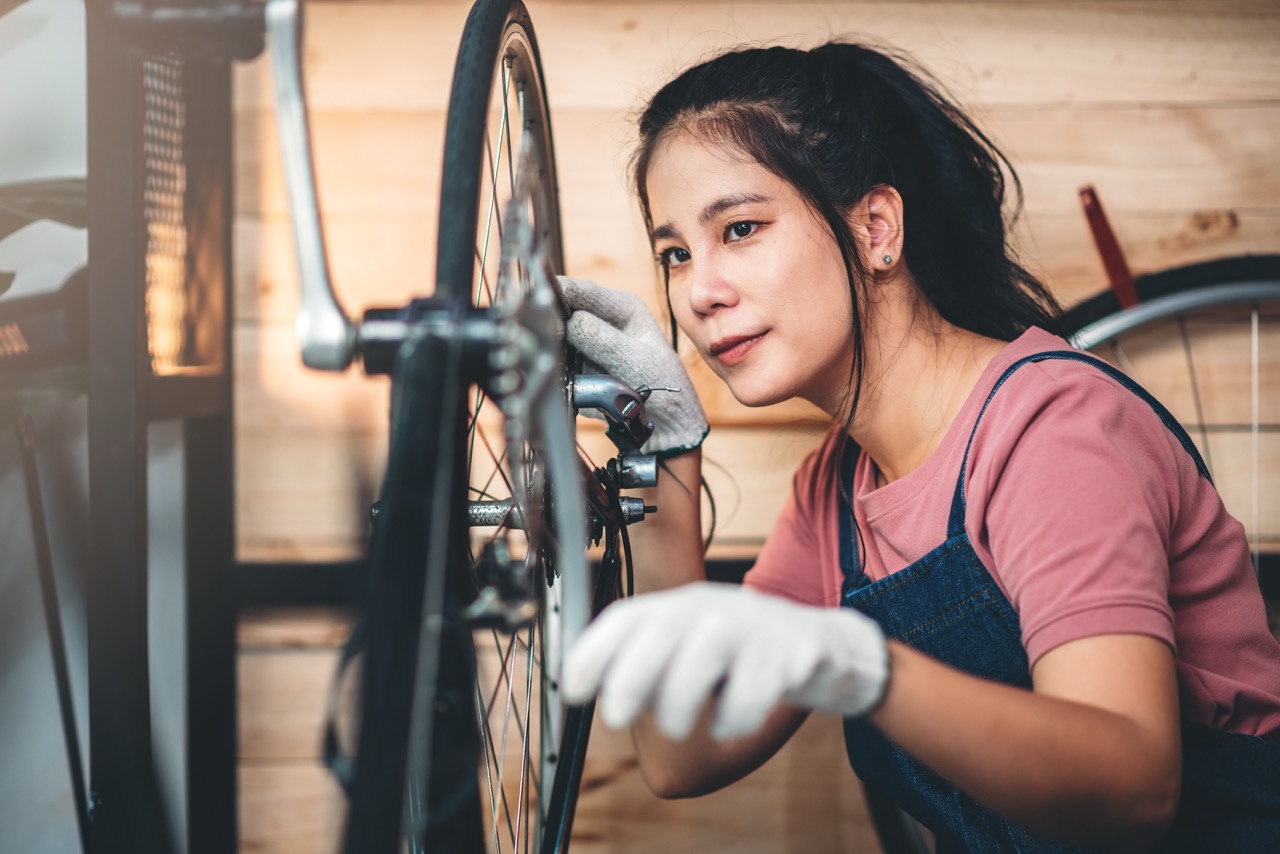 woman repairing bike