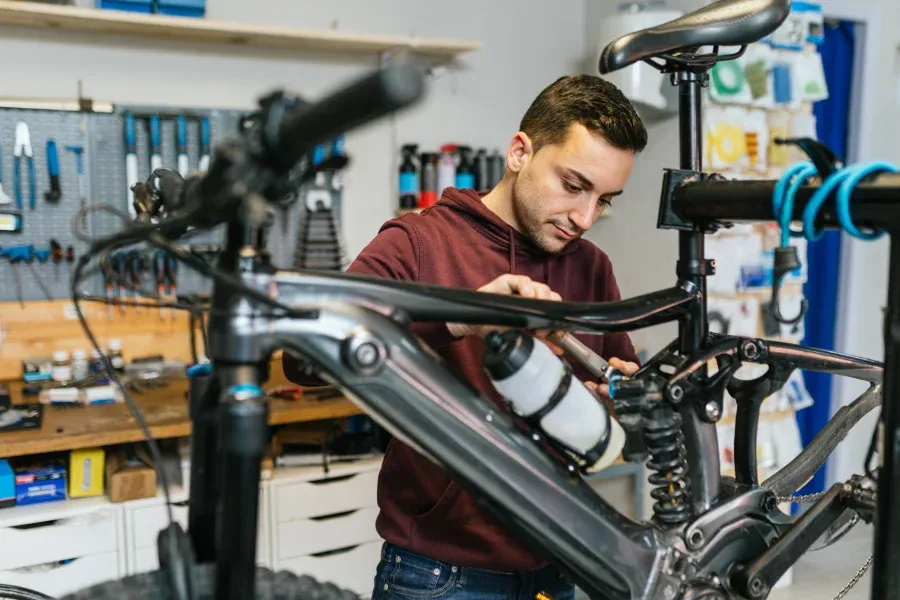 bike-mechanic-manipulates-the-suspension-system of ebike